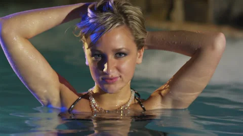 Blonde female model posing in a pool at night Stock-Footage 38183072