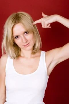 Blonde gesturing a shoot in her head Stock Photos
