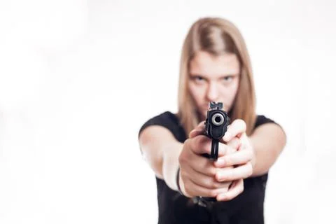 Blonde girl aiming with hand gun Stock Photos