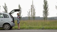 Blonde Calling Cellphone In A Panic Near Her Broken Car With Blonde Calling Cellphone In A Panic Near Her Broken Car With Open Trunk Onstock Footage