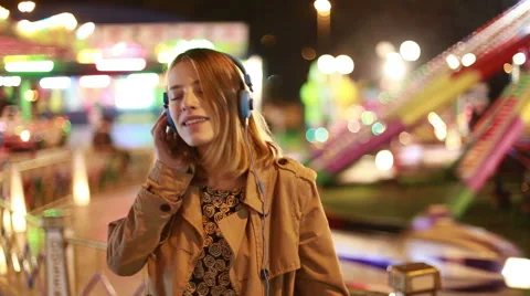 Blonde girl dancing to the rhythm of music with headphones Stock Footage 59556348