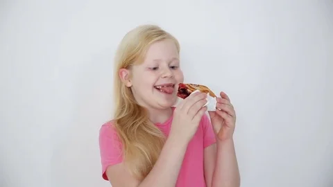 Blonde girl eats cherry pie on white background close-up Stock Footage 82223444