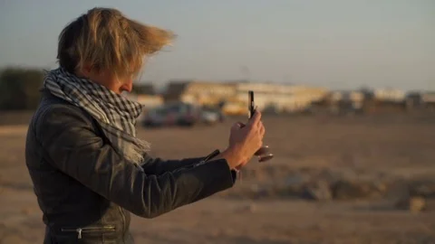 Blonde girl making a selfie in a desert slow motion Stock Footage
