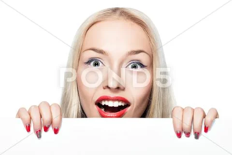Blonde girl peeking out from behind the poster. Stock Photos