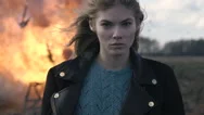 Blonde Girl With A Piercing Glance At The Background Of A Car Explosion Stock Footage