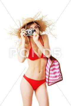 Blonde girl in red bikini is taking pictures Stock Photos
