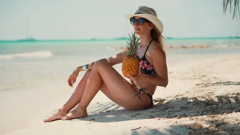 Young Beautiful woman in Bikini enjoying and relaxing on the beach