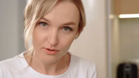Blonde girl at the work table, close-up. Freelancer takes notes. Video stock 153041875