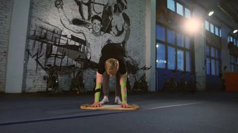 Blonde guy in black shirt doing hand stand. Stock Footage 96604955
