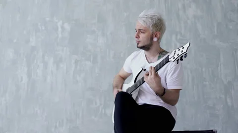 Blonde guy playing the guitar Stock Footage 103997286