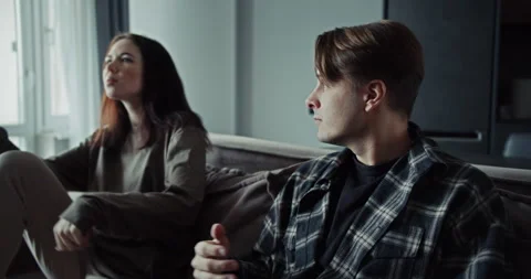 Blonde guy wants to make peace with his girlfriend while sitting on the couch Stock Footage 305773507
