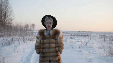 Blonde in a hat in winter Stock Footage 83832614