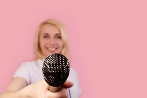 Blonde interviews on a pink background Stock Photos