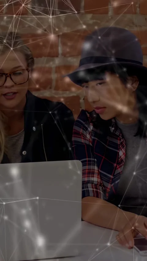 Blonde joining sparking collab, team leaning toward laptop, pointing and Stock Footage 331338060
