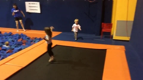 Blonde kid playing on trampoline Stock Footage 74504432