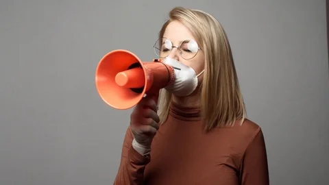 Blonde lady in face mask with megaphone Stock-Footage 126670153