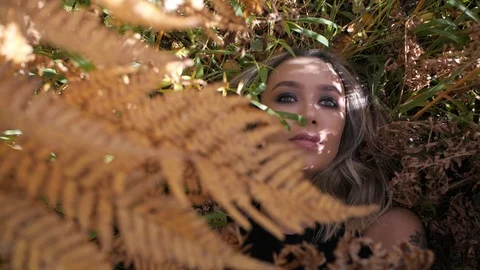 Blonde lies in the foliage Stock Footage 104098786