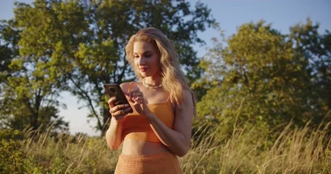 A blonde is looking for information on the phone Stock Footage 207098014
