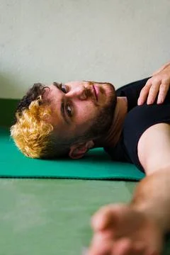Blonde man stretching looking at the camera Stock Photos
