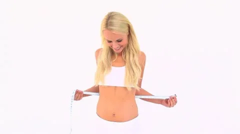 Blonde measuring her waist Stock Footage