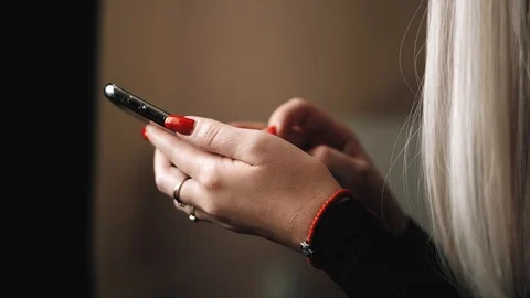 Blonde is messging with the iphone x Stock Footage 99701034