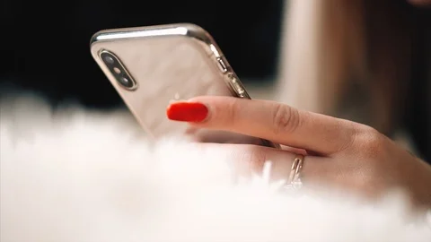 Blonde is messging with the iphone x Stock Footage 99701046