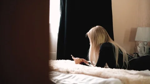 Blonde is messging with the iphone x Stock Footage 99701108