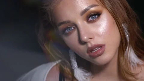 Blonde model with bright evening makeup. Beauty, fashion. Girl posing in studio Stock Footage 141085200