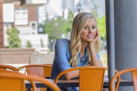  Blonde Model At A Cafe A blonde model sitting at a cafe in a city setting... Stock Photos