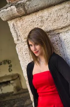 Blonde model dressed in red in a seductive pose 库存照片