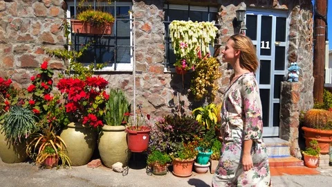Blonde Model on the Front Yard with a Flower Facade in the Background Video stock 111835539