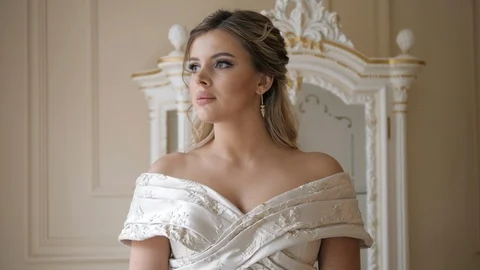 Blonde model with nice makeup poses against room furniture Stock Footage 121811147