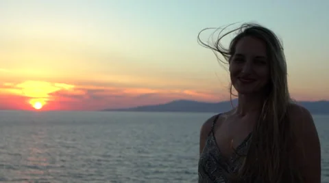 Blonde model smiling into camera ocean sunset silhouette mykonos greece Stock Footage 67980409