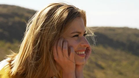 Blonde Model Smiling with her Hands Against Her Cheeks Stock Footage 114325186