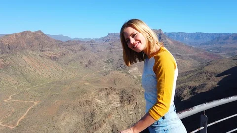 Blonde Model Smiling with an Overlooking View of the Valley Stock Footage 111835100