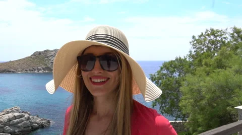 Blonde model walking large hat ocean background greek island slow motion Stock Footage 67973885