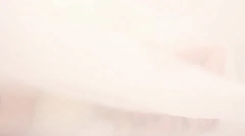 Blonde model in white bed, seen from above Stock Footage 21815577