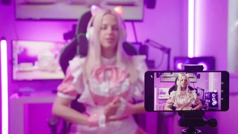 Blonde pink maid gamer influencer recording video with smartphone 4K Stock Footage