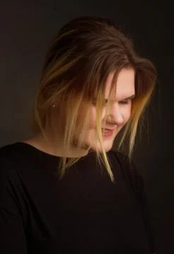 Blonde Plus Size Model on black background in dark clothes Stock Photos