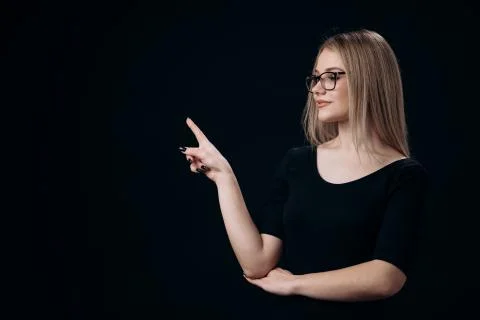 Blonde pointing with finger on empty space Stock Photos