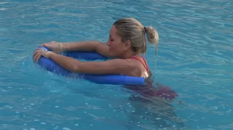 Blonde in the pool making pilates Stock Footage 41421925