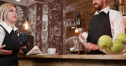 Blonde pretty waitress talks to her male colleague Stock Footage 104866129