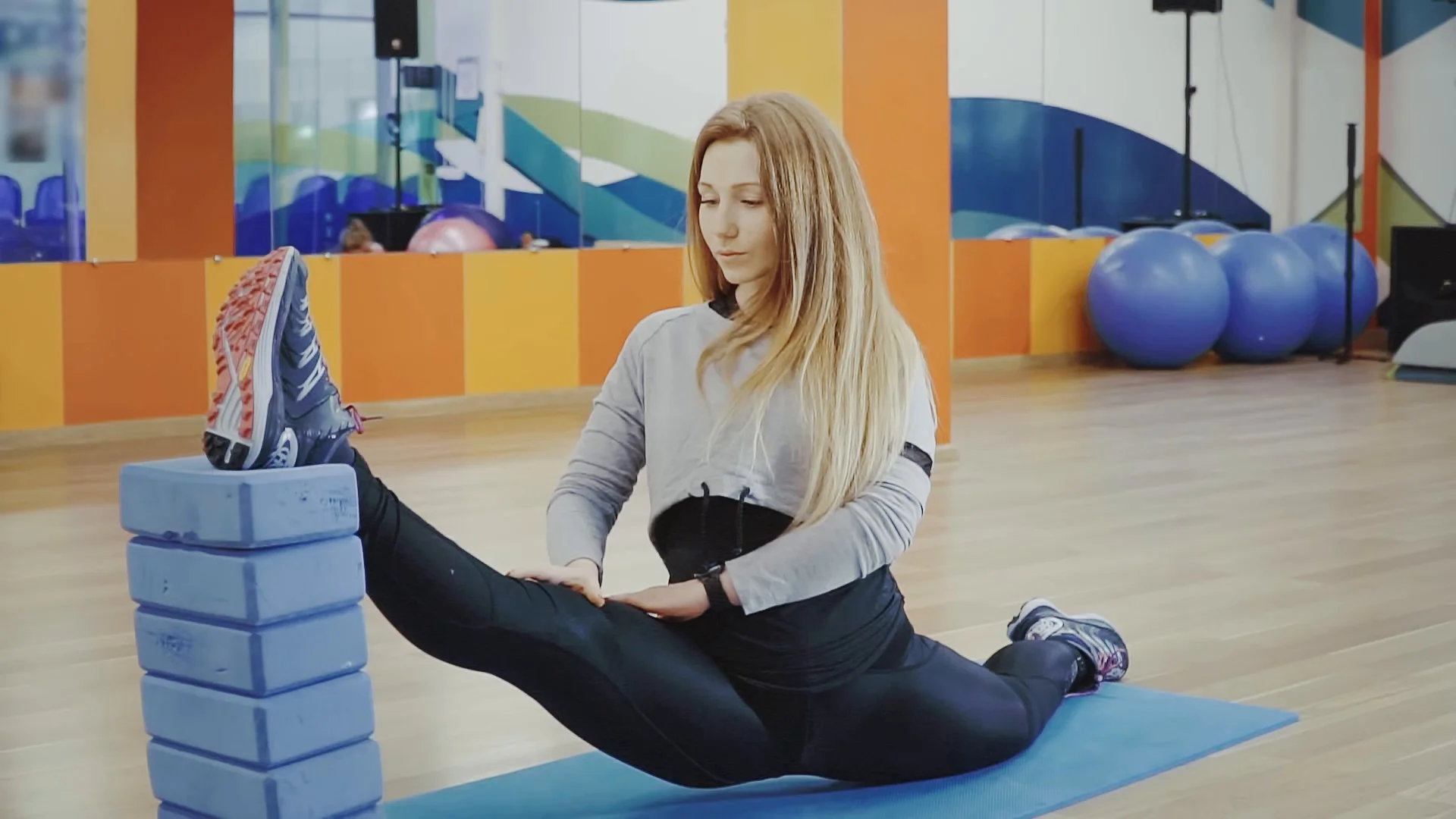 Cute brunette woman lying on yoga mat at home, doing fitness