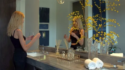 Blonde putting on Makeup Stock Footage 99480393