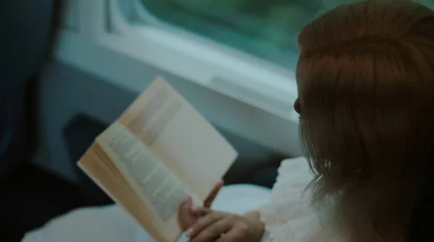 Blonde reading a book in the train Stock Footage 59799452