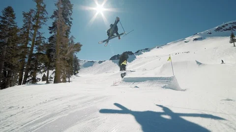Blonde skier does crazy trick off jump in sunny mountains extreme action Видео 103822628