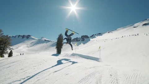 Blonde skier does crazy trick off jump in sunny mountains extreme action Видео 103822826