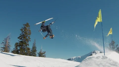 Blonde skier does crazy trick off jump in sunny mountains extreme action Видео 103822918