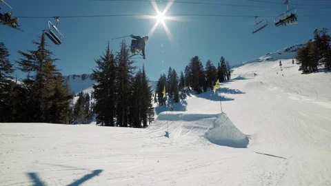 Blonde skier does crazy trick off jump in sunny mountains extreme action Видео 103823232
