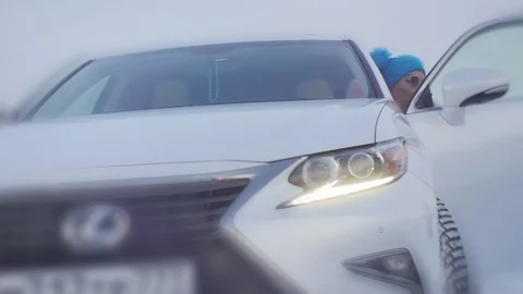 The blonde in the spectacles comes out of the White Machine Stock Footage 84121943